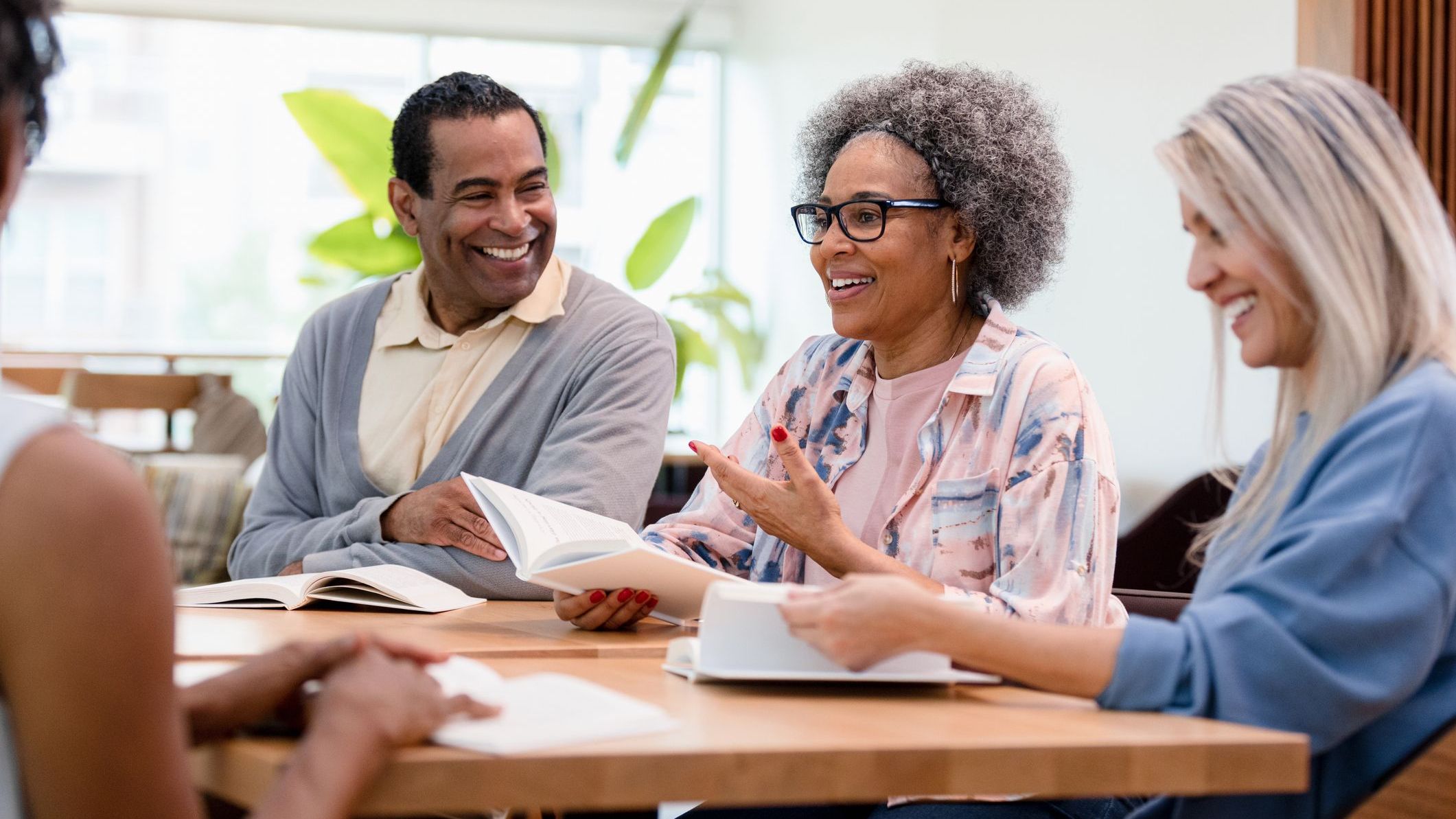 A book club for retirees discusses the book they just finished reading. 