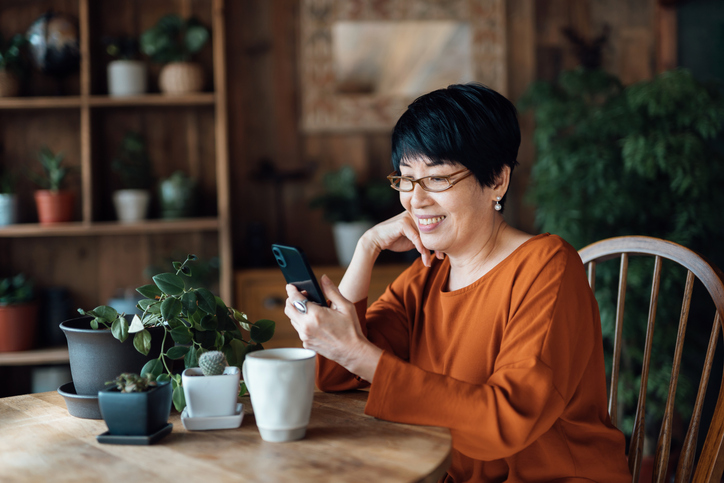 A woman reviews her tax return progress after filing health savings account tax form 8889. 