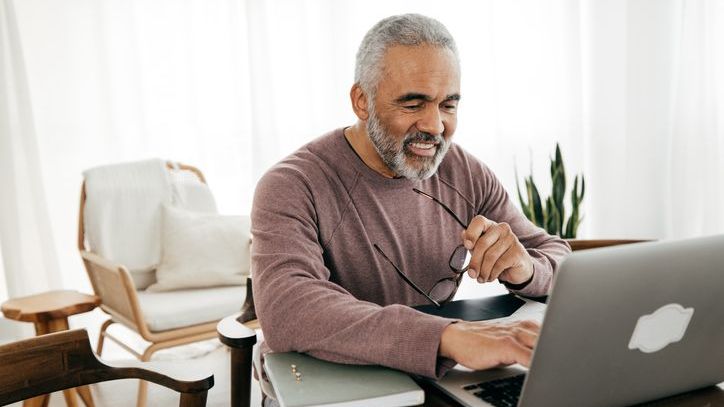 A man requests a direct rollover of retirement funds from his computer.  