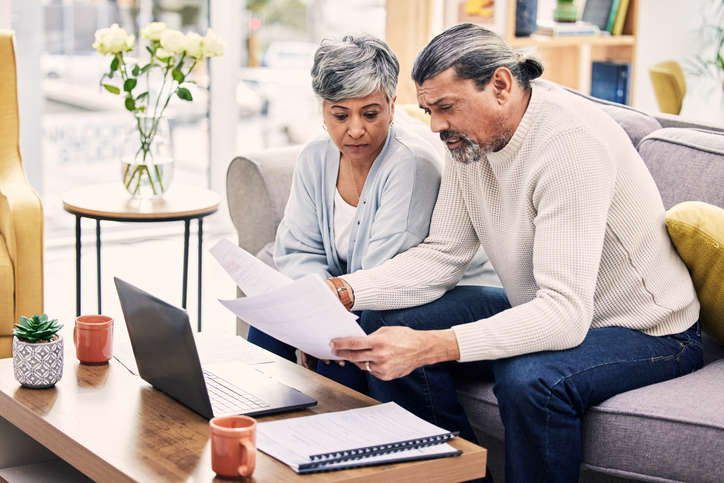 A couple researching retirement withdrawal strategies.