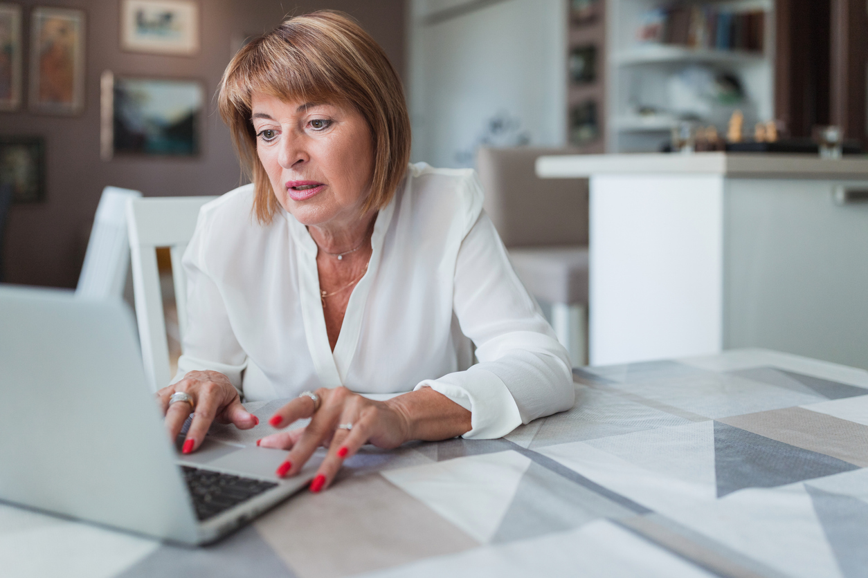 A senior looking up how to claim spousal survivor benefits.